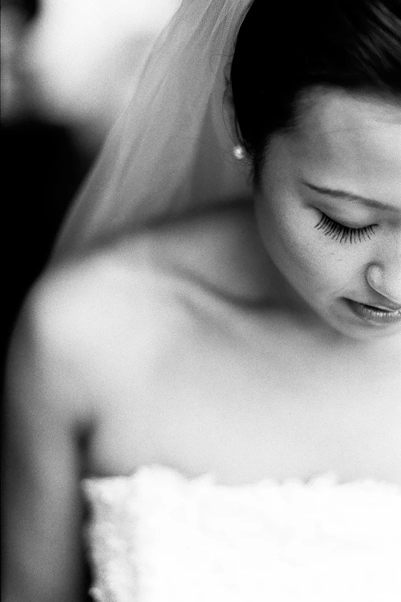 Bride looks at the rain on the balcony at Sorrento Hotel in Seattle, WA