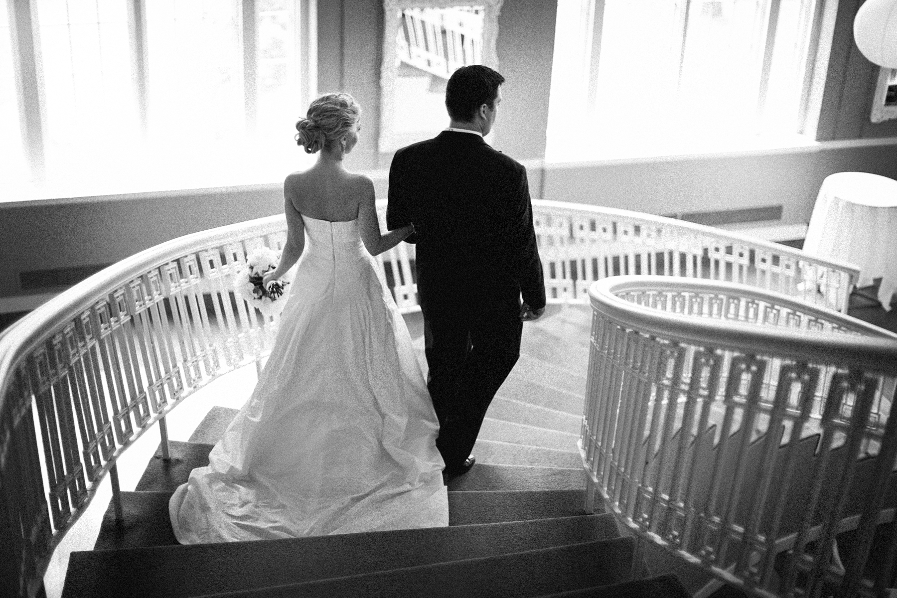Bride and groom walk down to their reception at Calhoun Beach Club in Minneapolis, MN