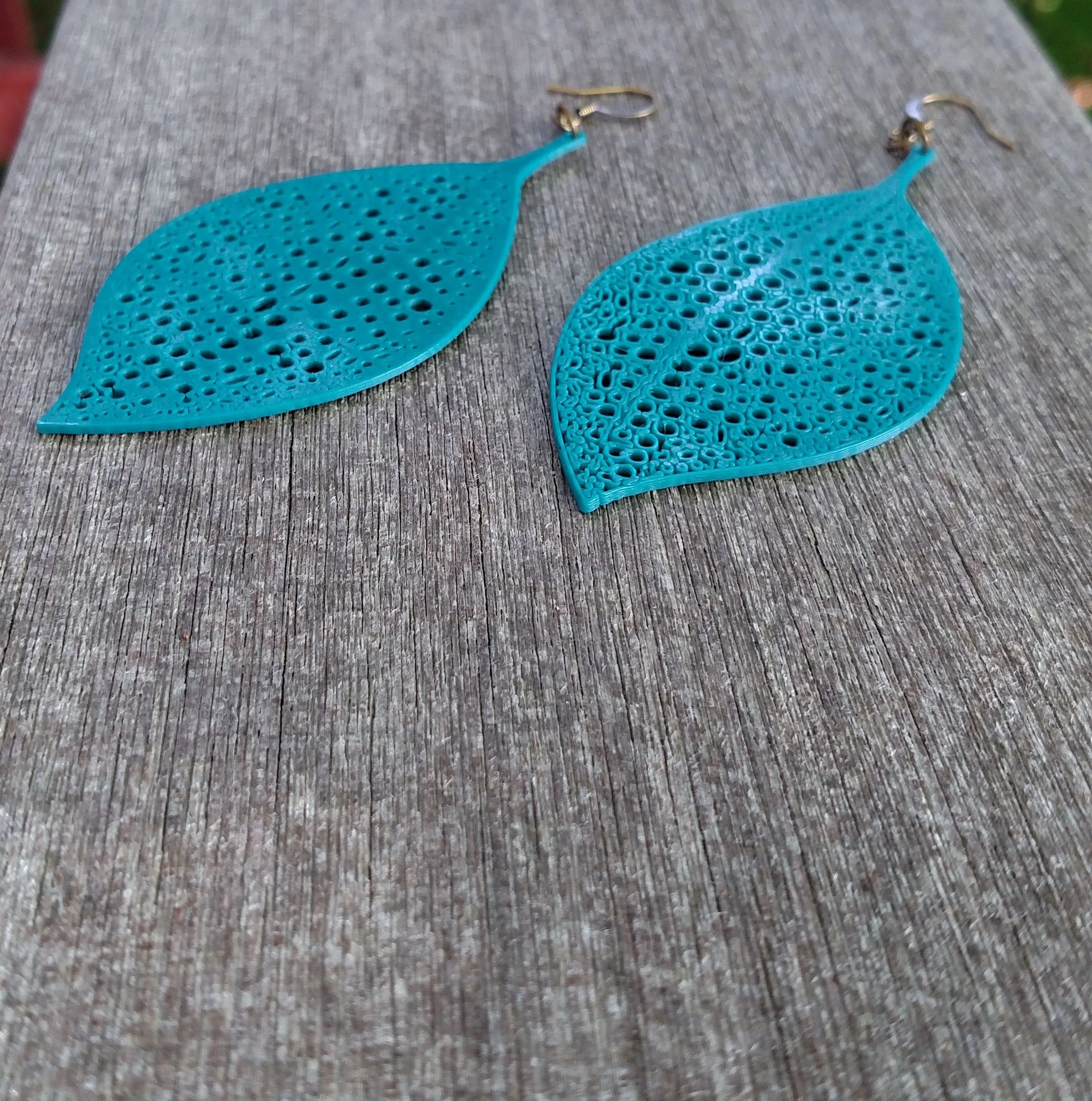 Dark Teal Catepillar Leaf Earrings Ear ANgled.jpg