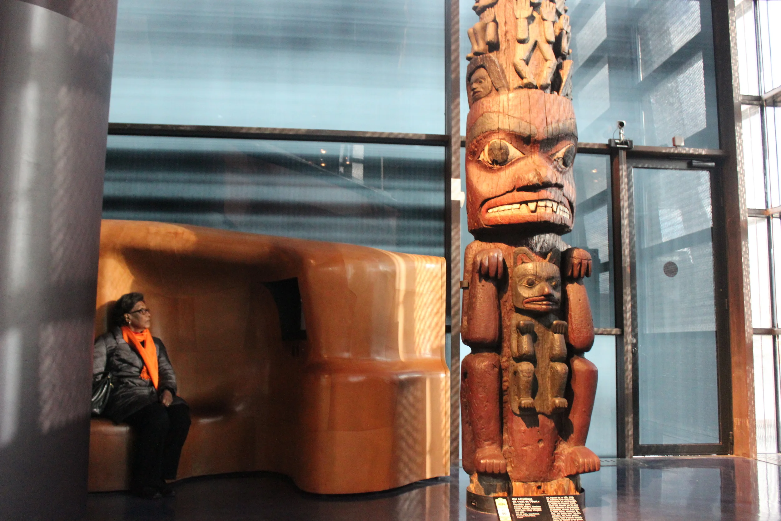 Gran taking a rest in front of a bear wolf totem in the Musée du Quai Branly