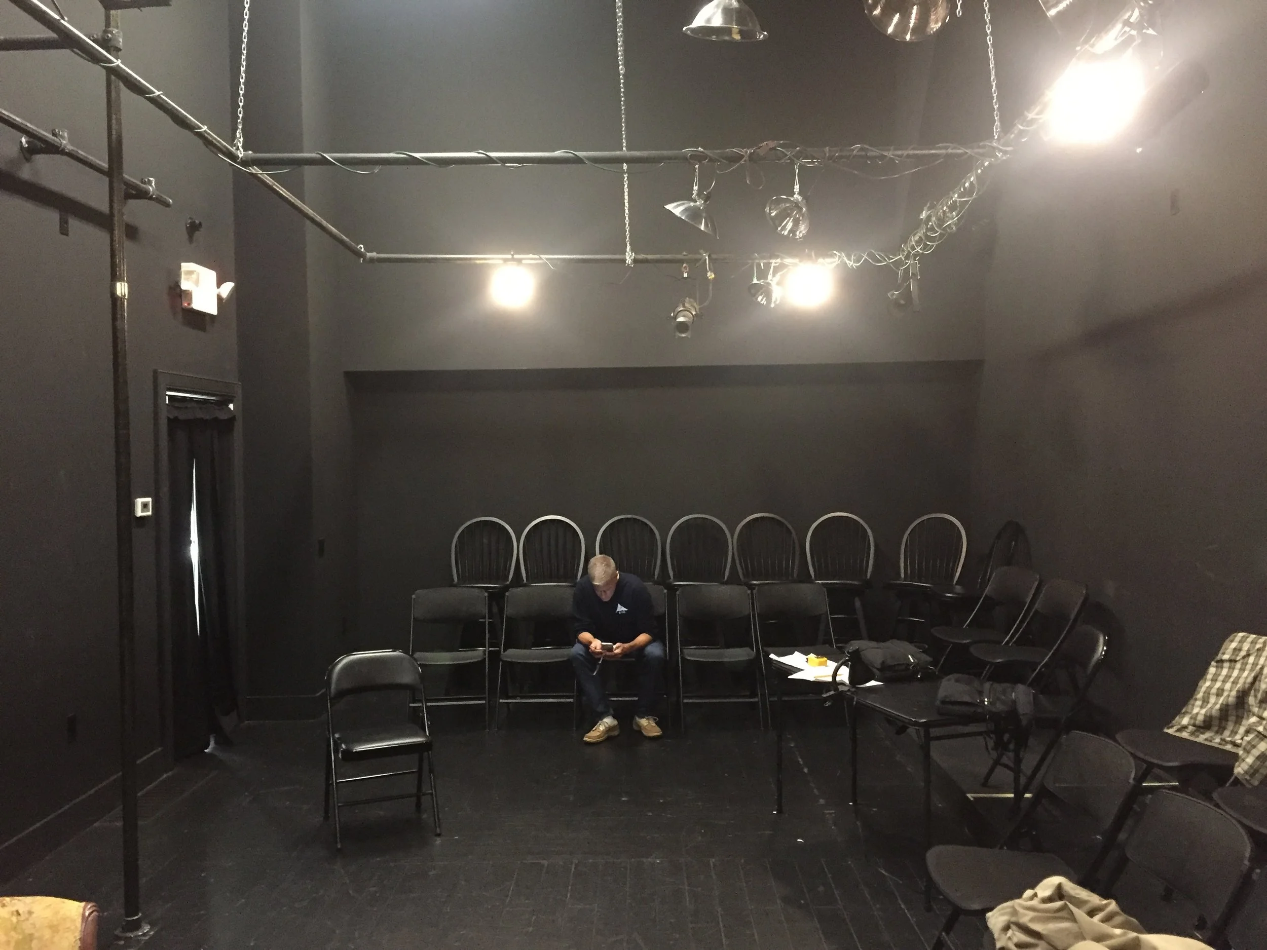 End to end at the black box – a marvelously intimate space to perform, but echo-y as heck. Note the clamp-on lights with the aluminum shades – just a few paper clips and gel and we were golden. (Rob Phelps – my man – is checking his email.)