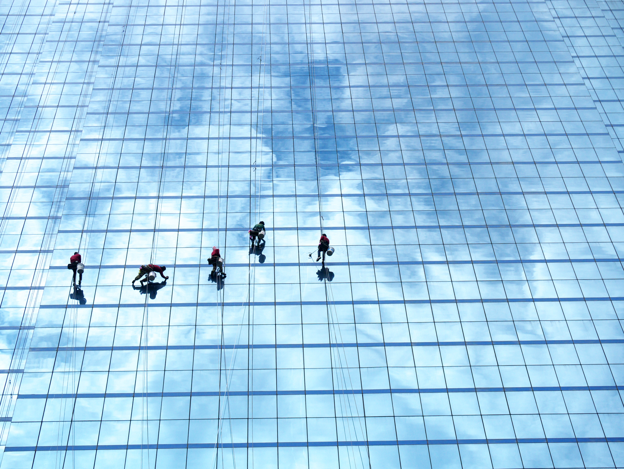 window cleaners cleaning high rise building.png