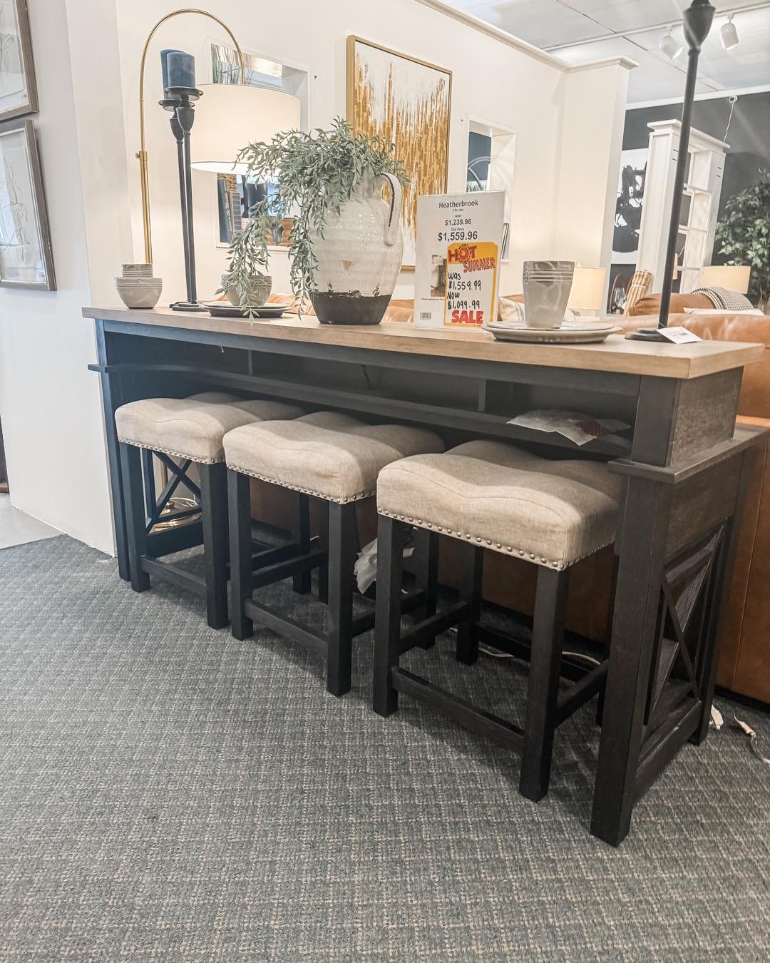 Take Me Home Today ☀️ 

This unique console bar table would be the perfect accent piece in any home! This piece features a charcoal and ash finish, appealing open grid end panels, two electrical outlets and USB ports for easy access charging! 

Don&r