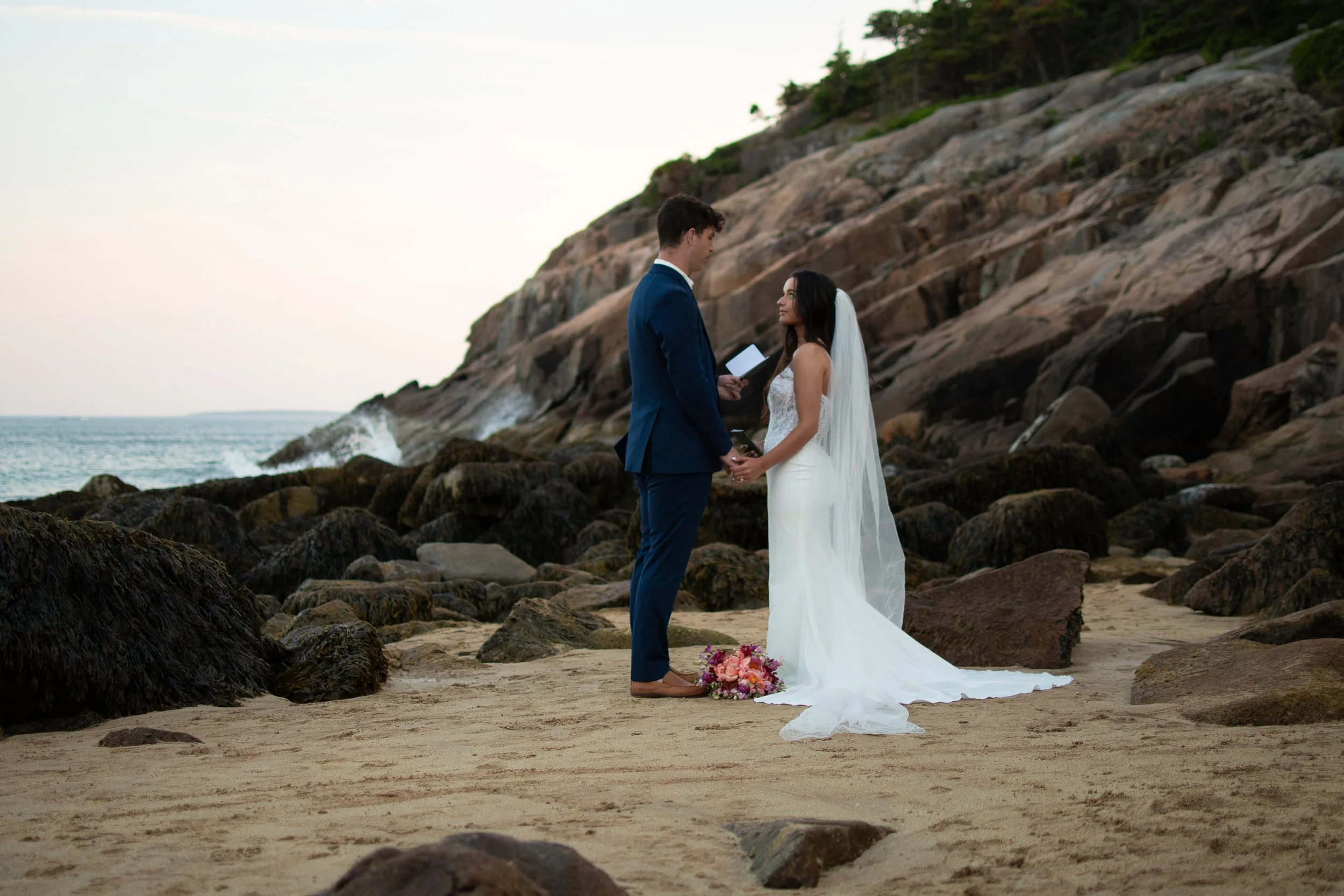 Couple exchanging vows on Sand Beach, Acadia