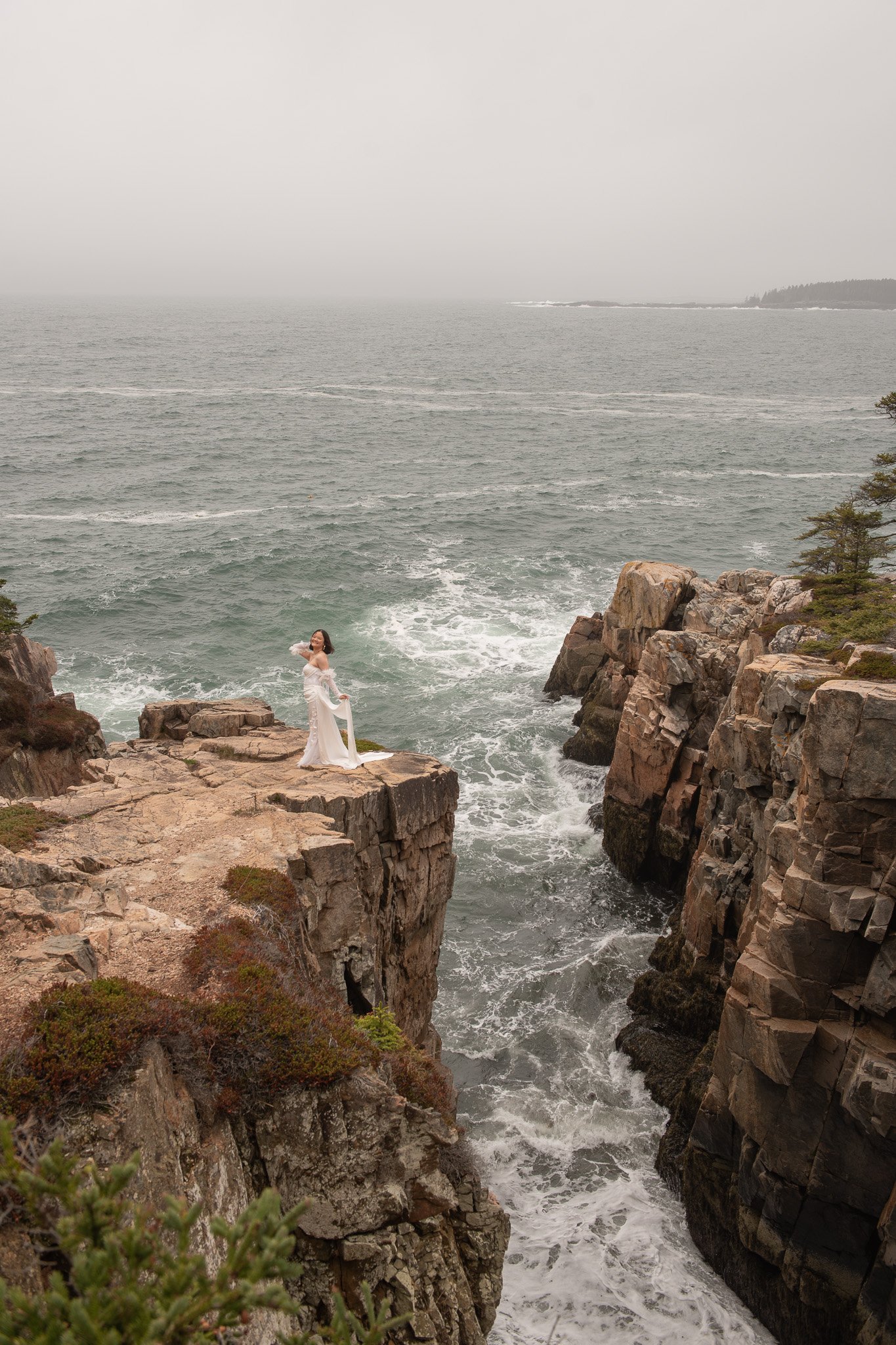 bride on cliff by acadia elopement photographer