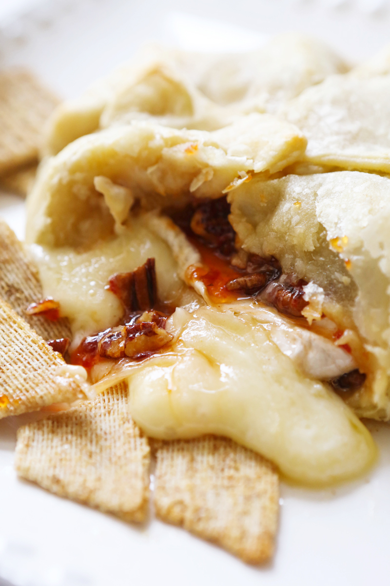 Gooey brie spilling out of baked crust