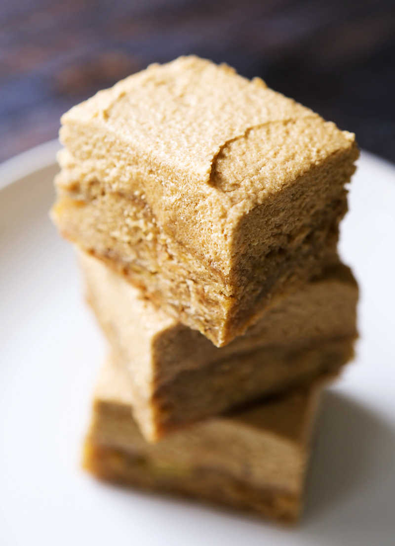 tall stack of bars with frosting on tops