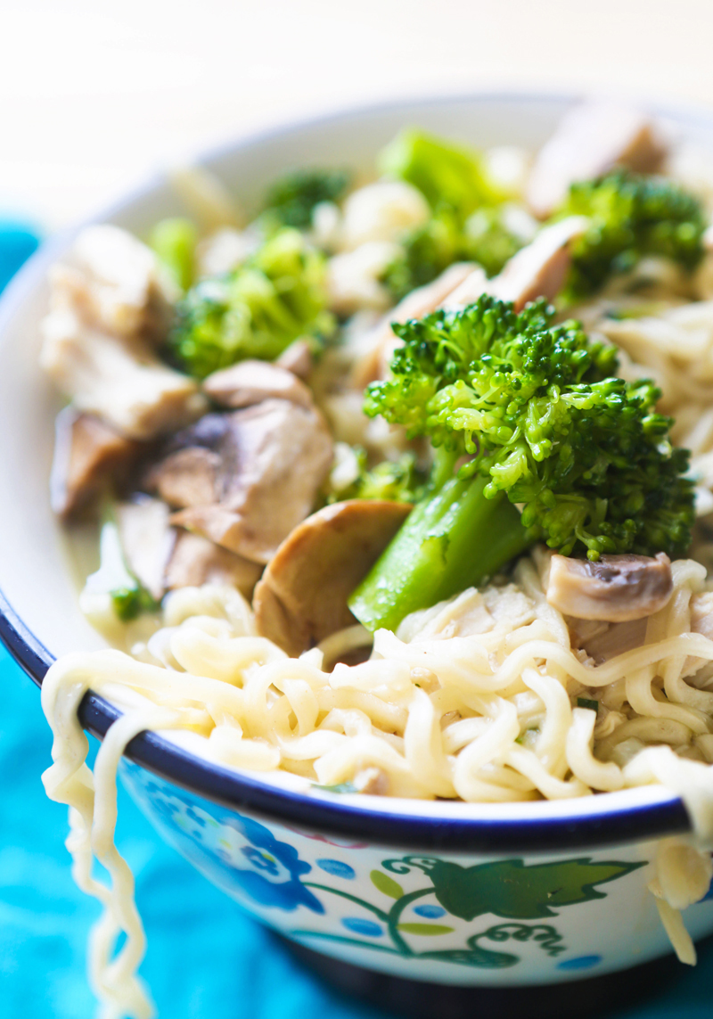 side view of a bowl with ramen bowl recipe with broccoli and mushrooms in it