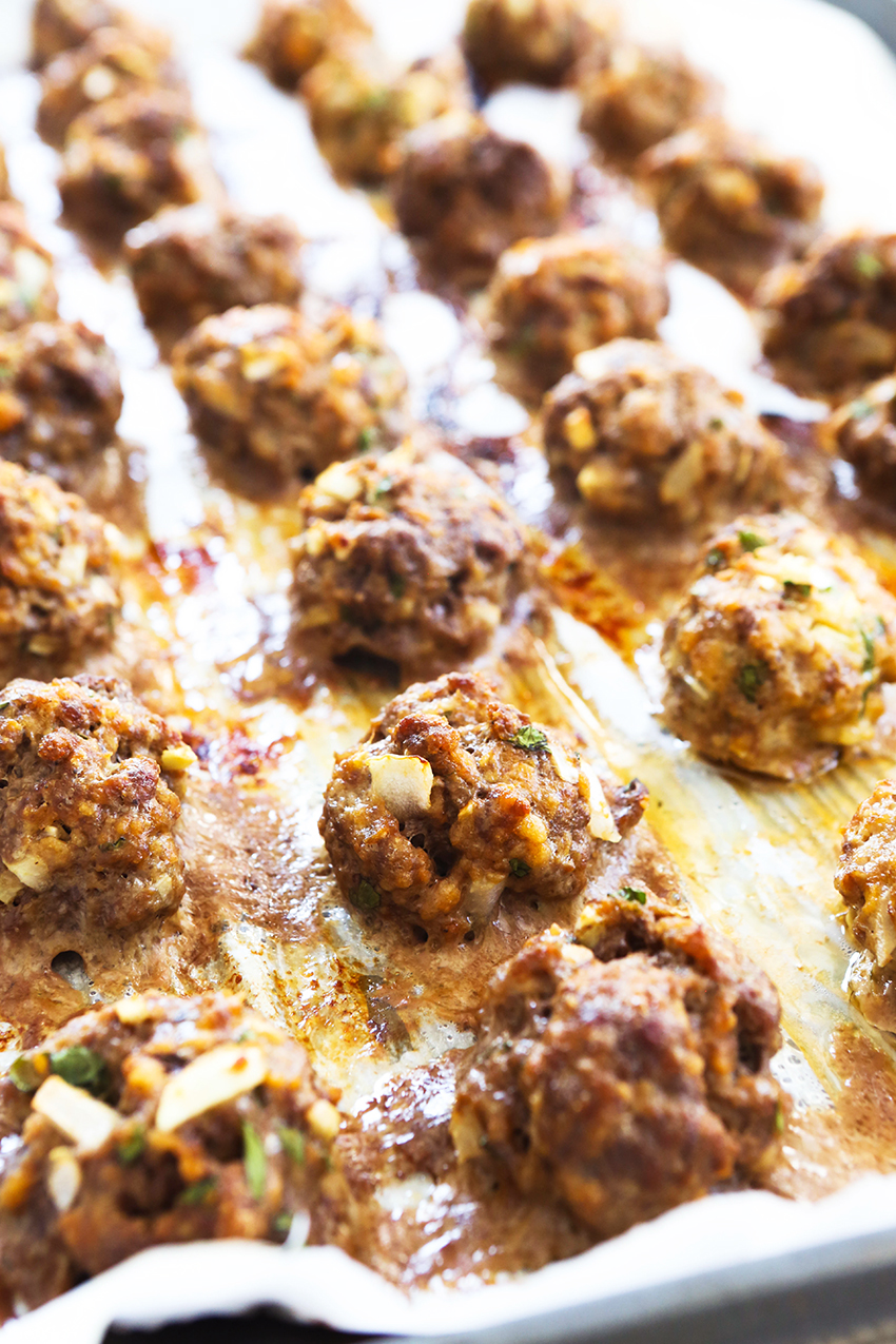 Close up of baking sheet with baked meatballs