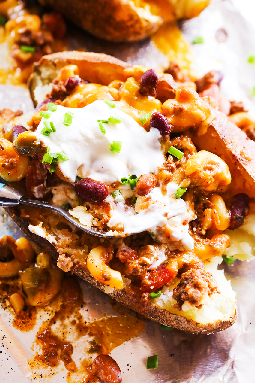 Fork sticking into a loaded potato.