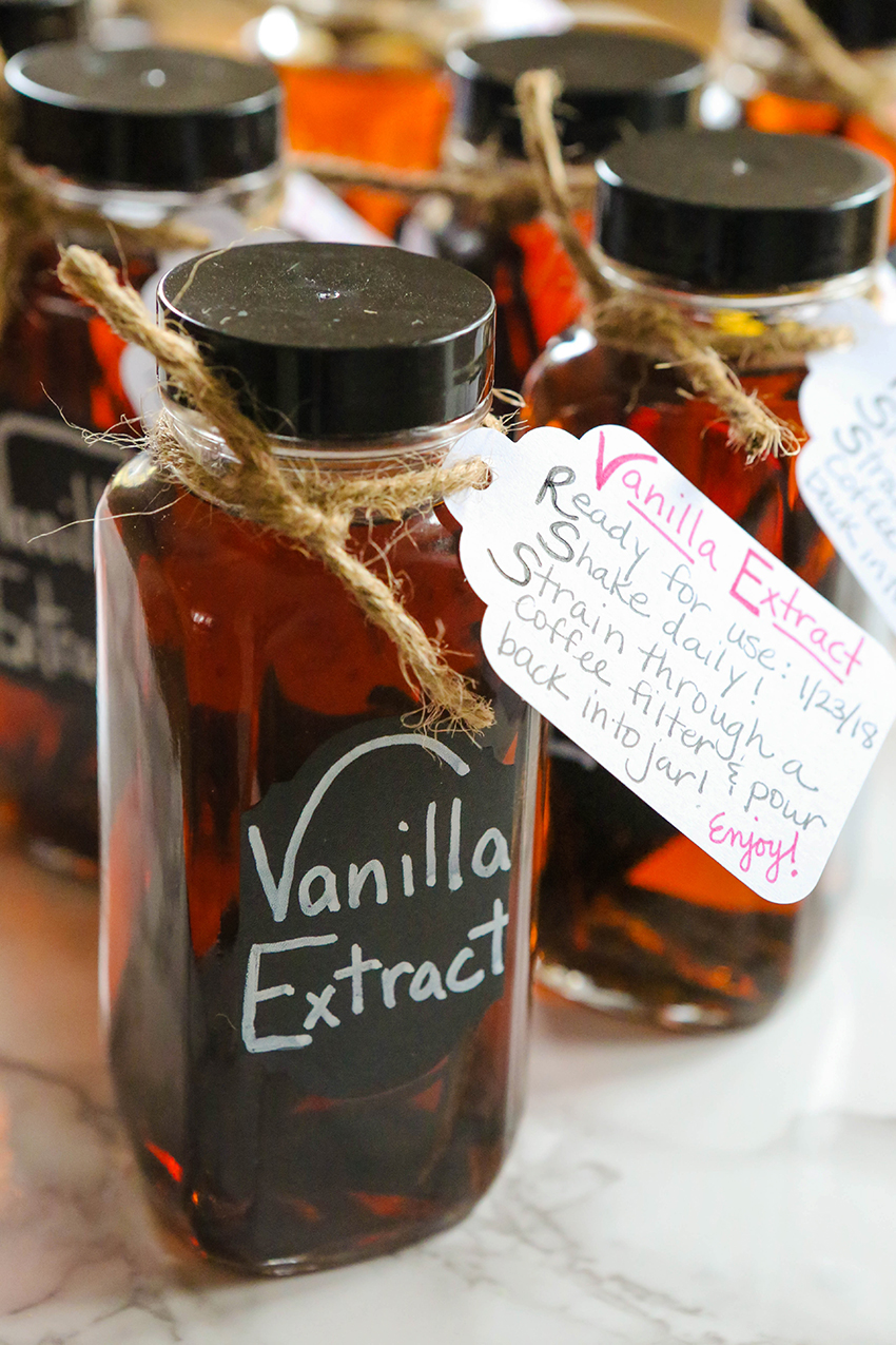 jars of vanilla extract lined up with instruction tags attached