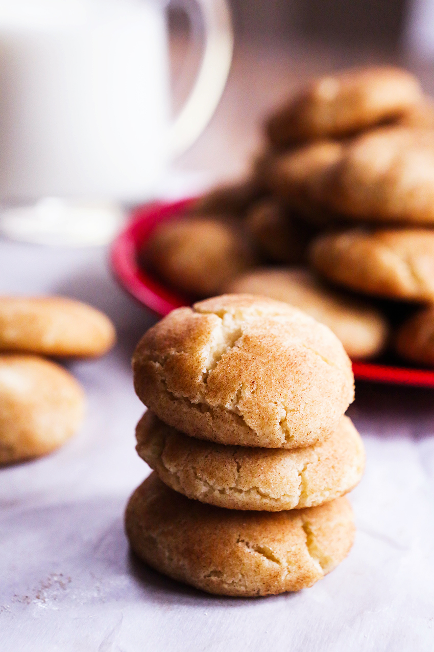 three snickerdoodles stacked in front of serving plate