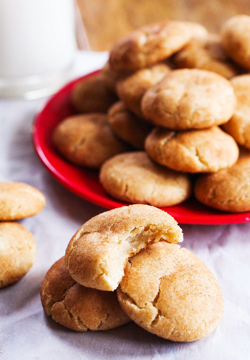 Stacked snickerdoodles with a bite taken out of the top one