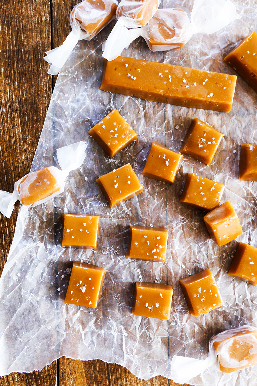bourbon caramels with salt cut into squares on wax paper