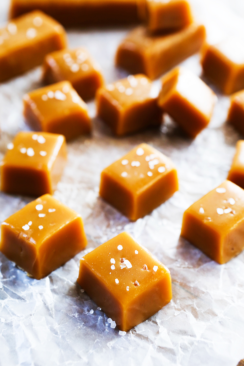 salted caramels lined up on a piece of wax paper