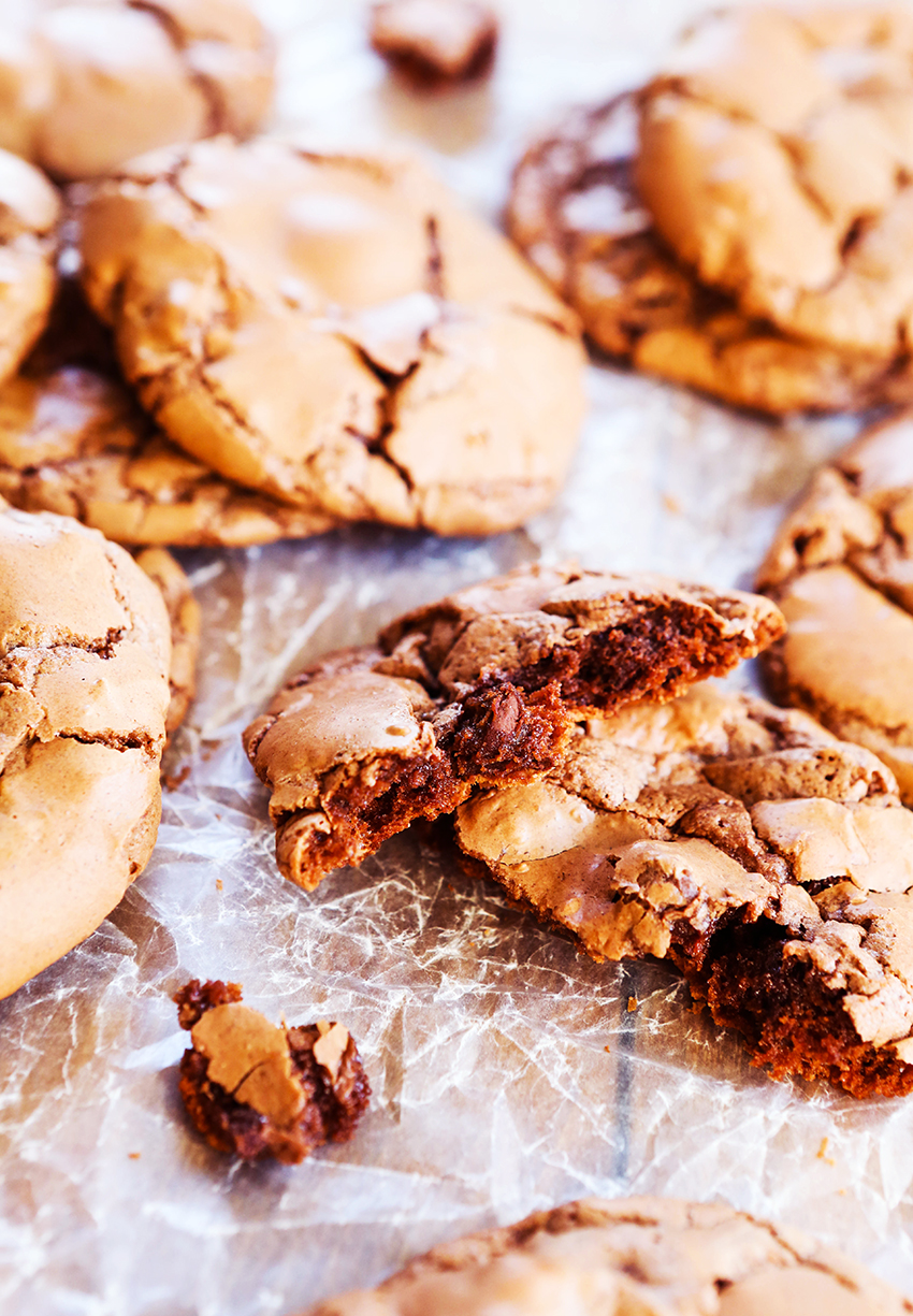 crinkly chocolate cookies stacked on a piece of wax paper