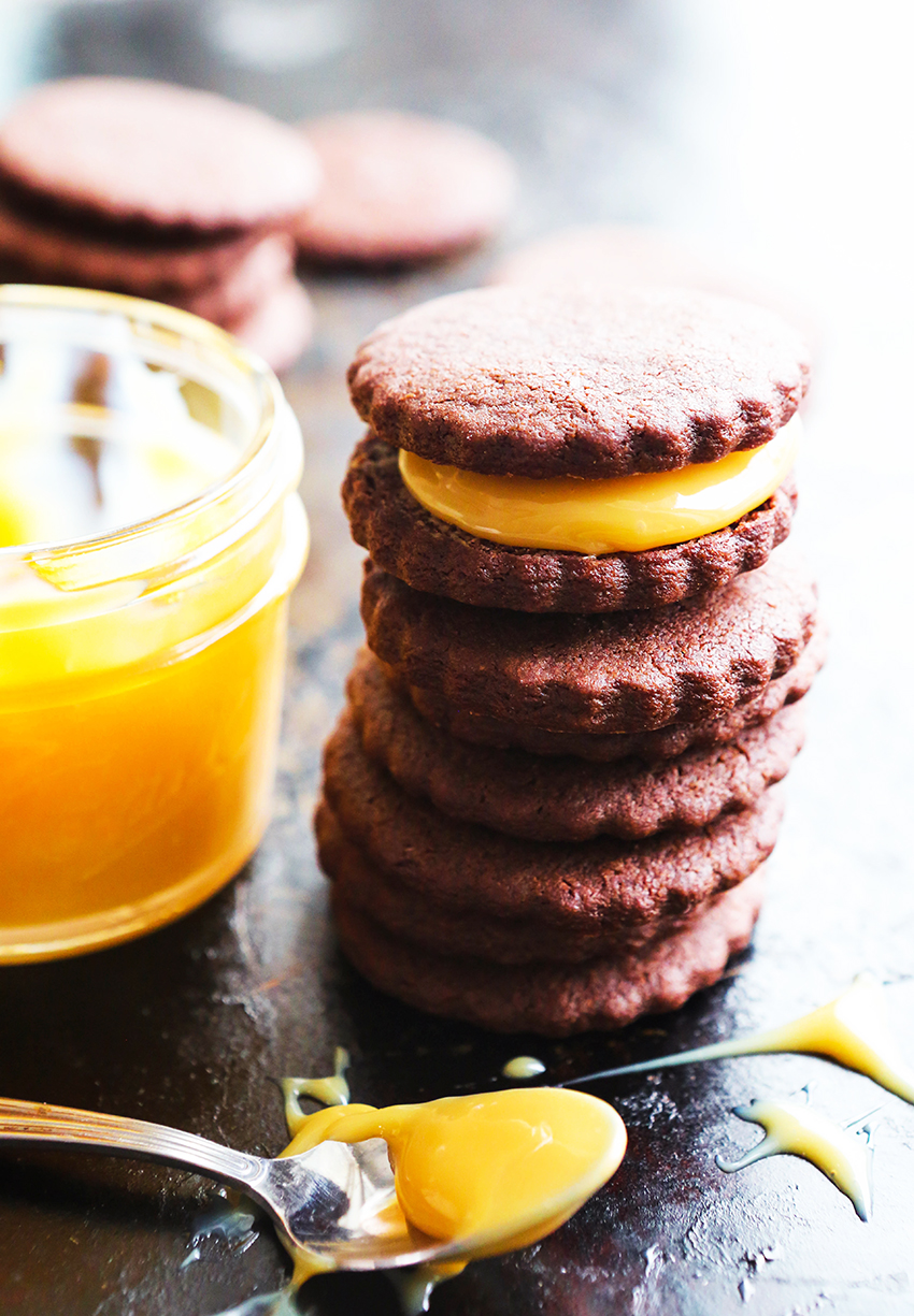 chocolate cookies stacked with the top sandwiching drippy dulce de leche