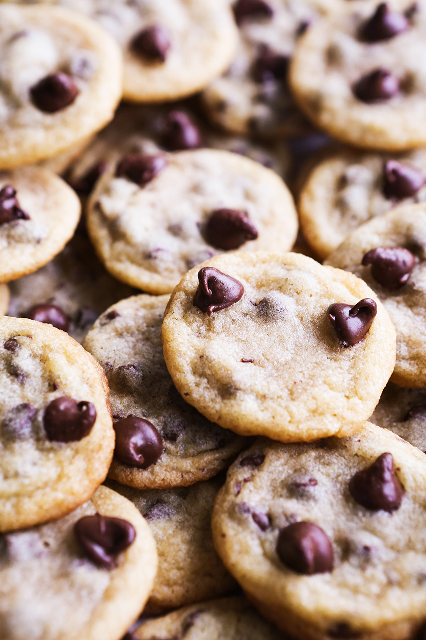 close up of a huge pile of miniature chocolate chip cookies