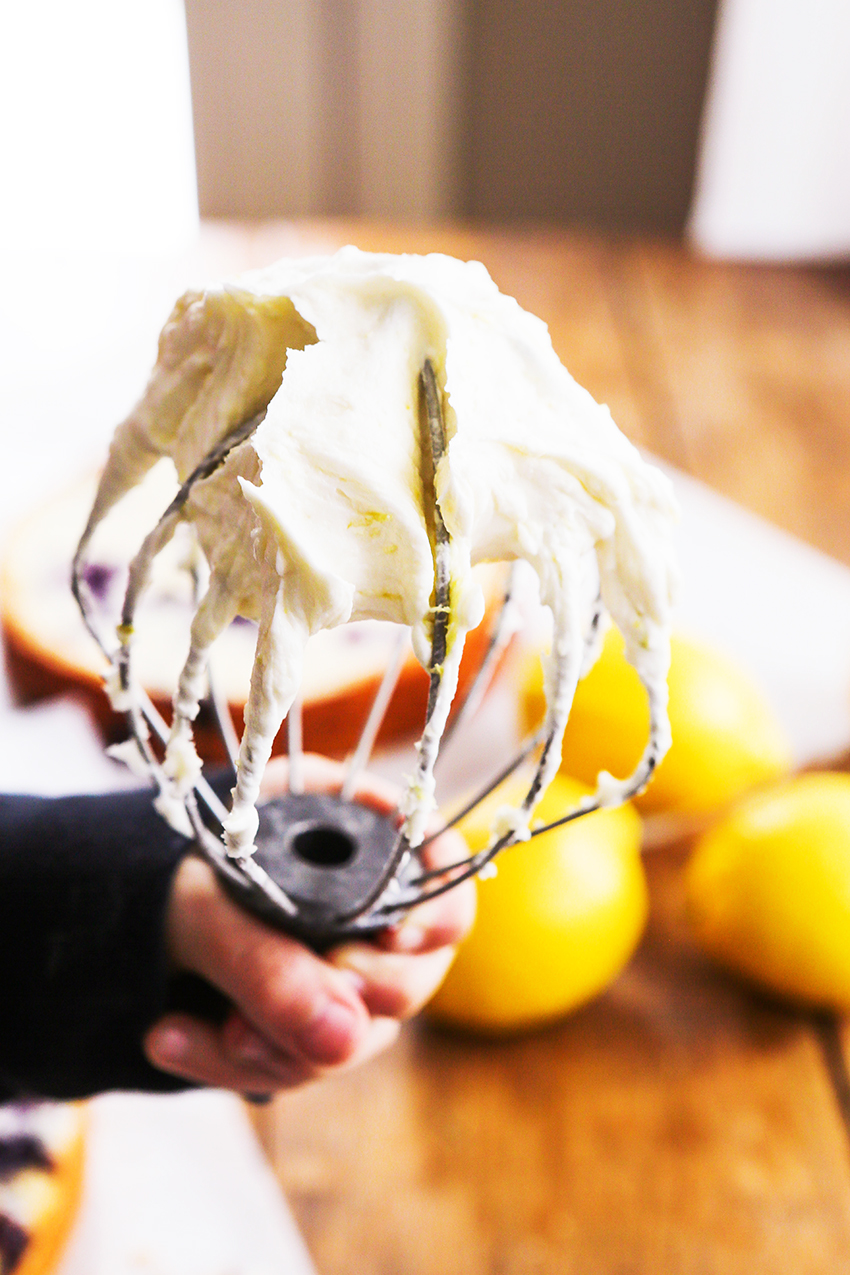 whisk attachment with lemon buttercream frosting billowing from it