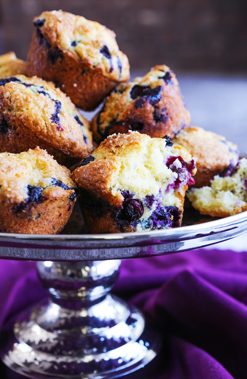 stack of homemade blueberry muffins on a silver cake stand