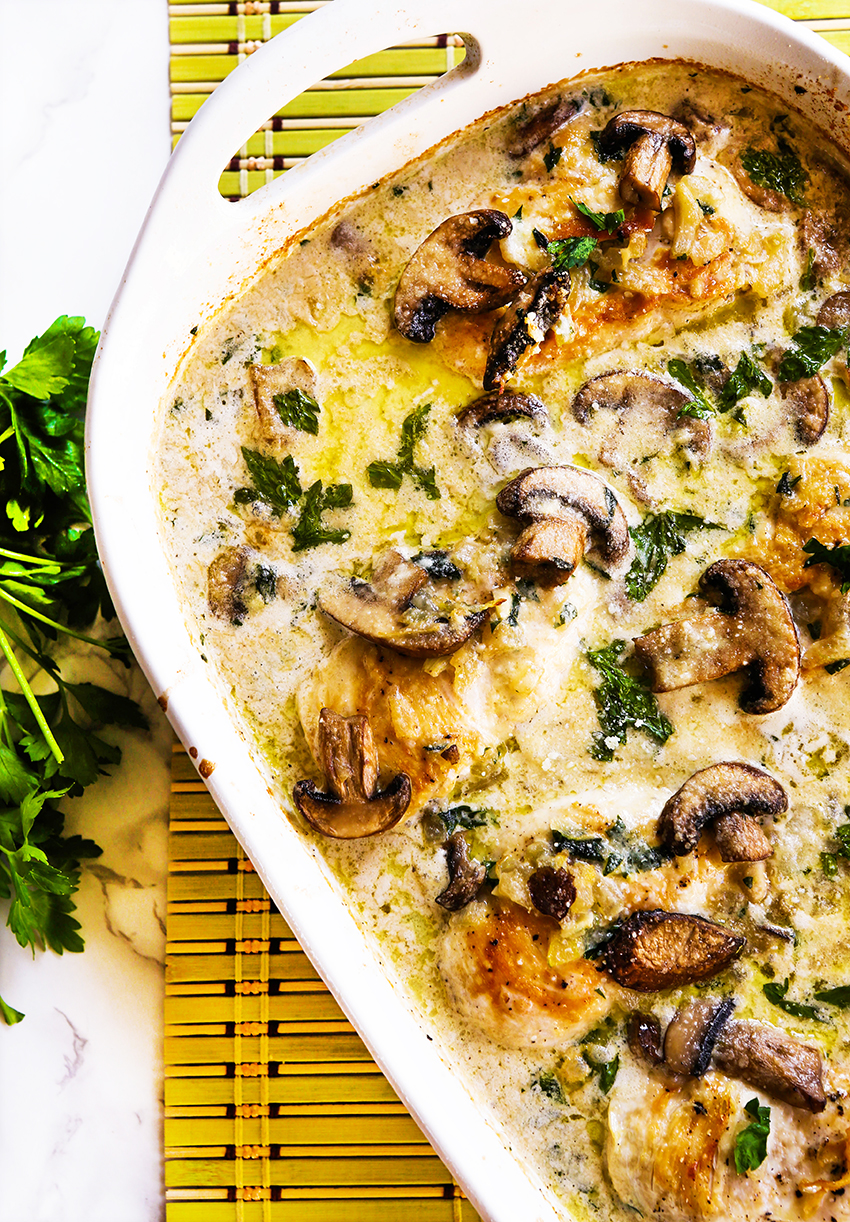 top view of baking dish packed with chicken, cream and mushrooms