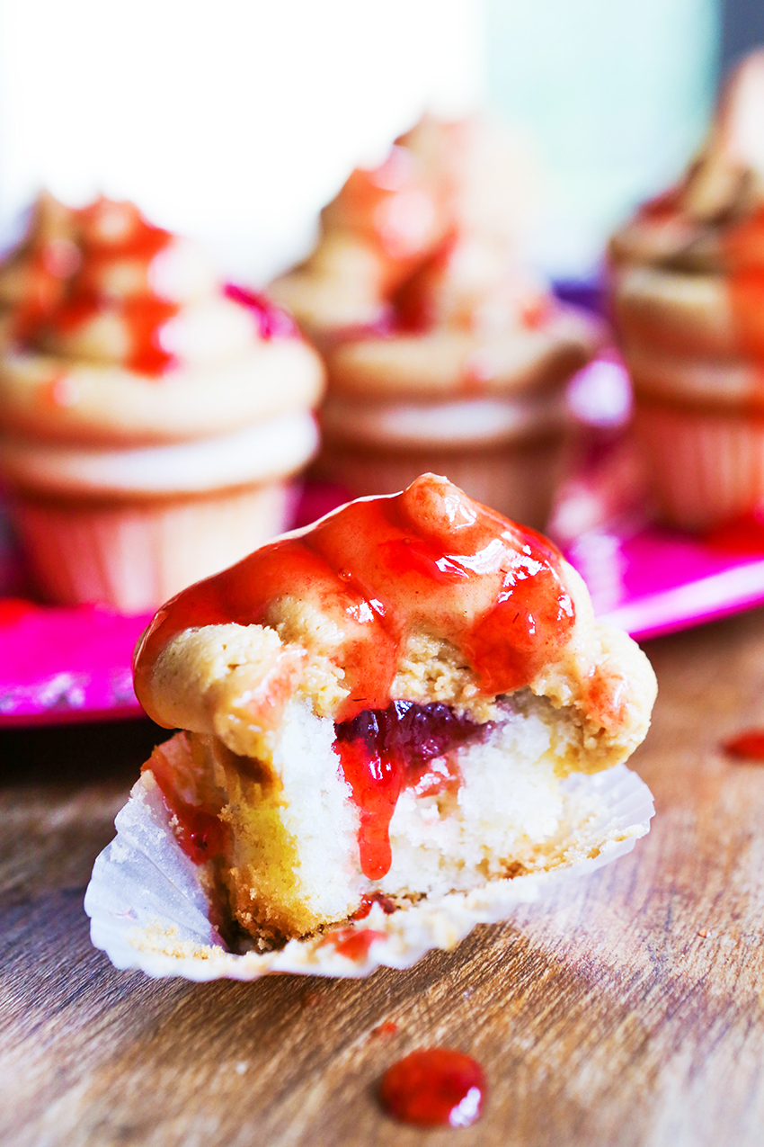 peanut butter cupcake cut in half with jelly oozing out from center