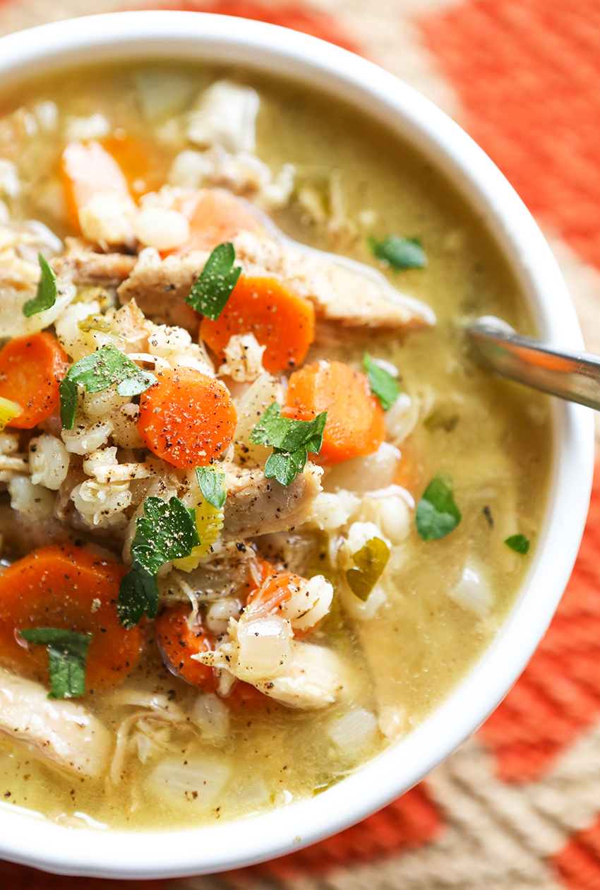 spoon inside a bowl of turkey barley soup