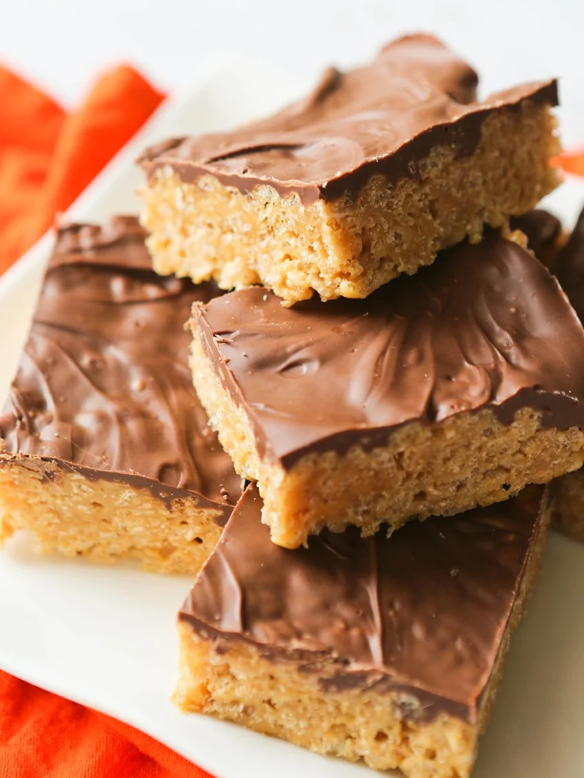 Rice Krispies treats stacked on a white serving platter