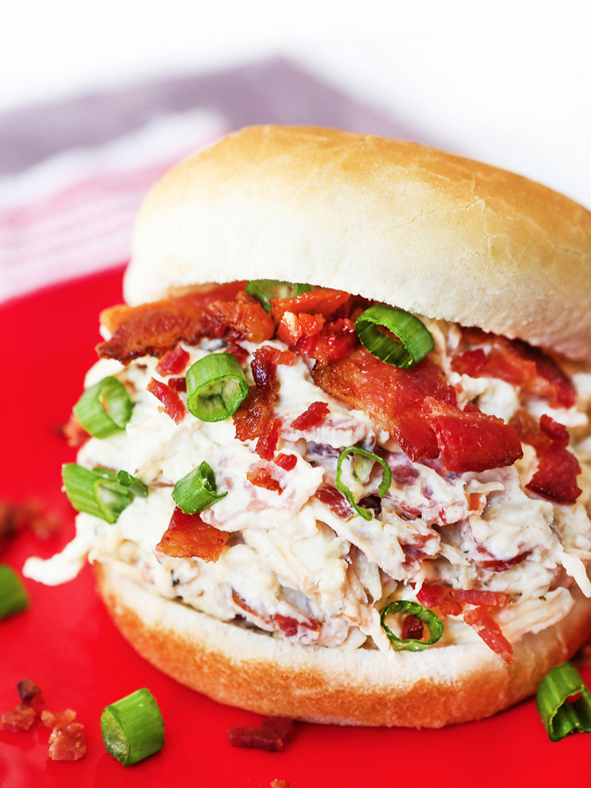  Crack chicken sandwich loaded with green onions and bacon pieces 