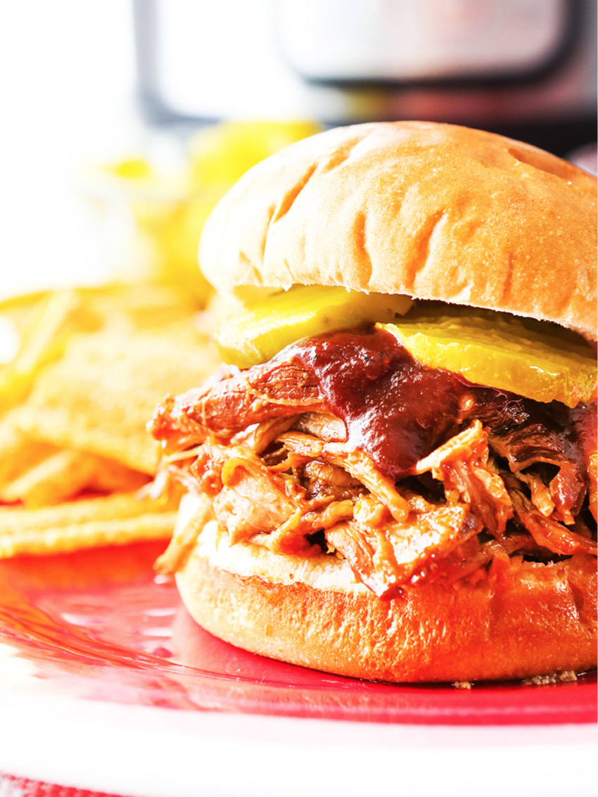  BBQ pulled pork sandwich on red plate 