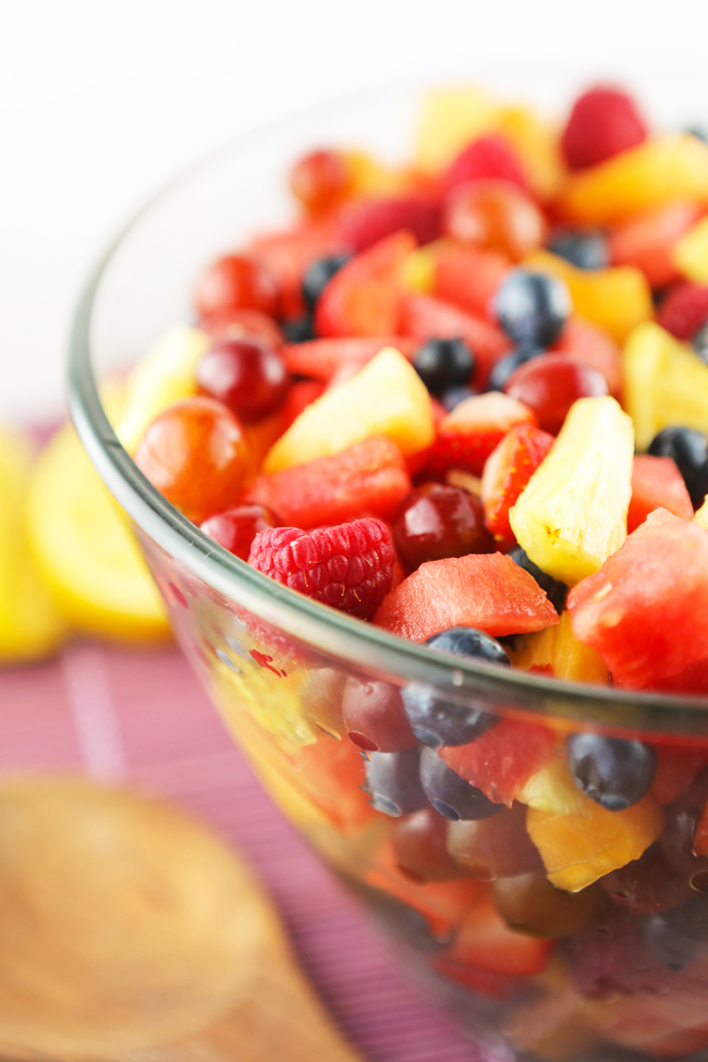 Side view of a bowl of freshly chopped fruit