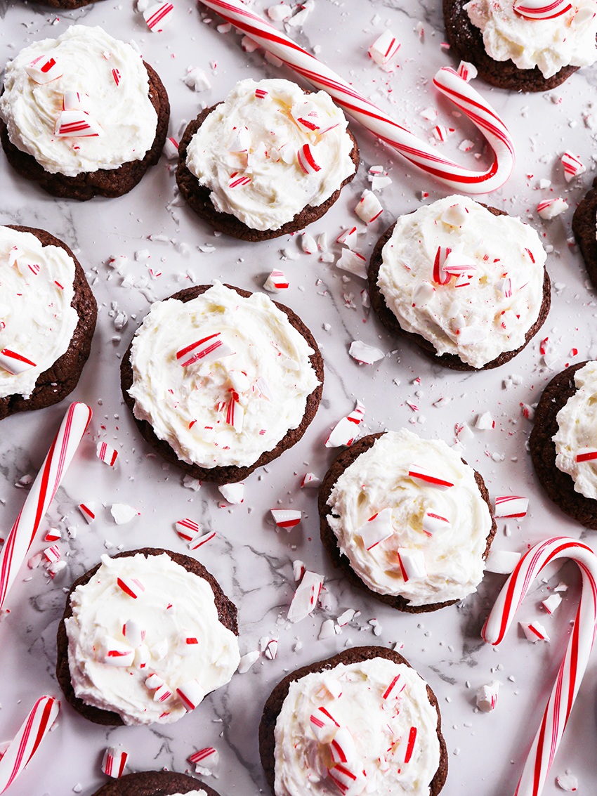 top view of cookies lined up with frosting and covered in candy cane pieces