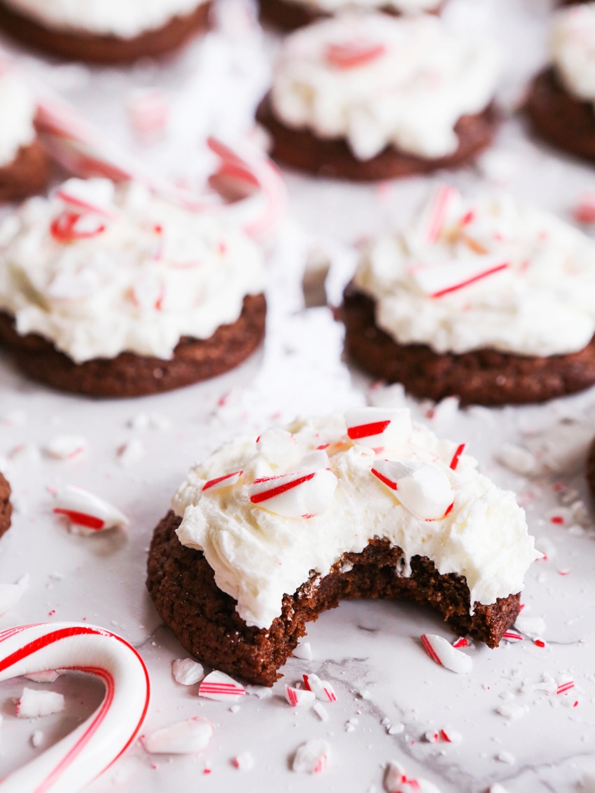 close up of chocolate cookie with candy cane pieces and bite taken out
