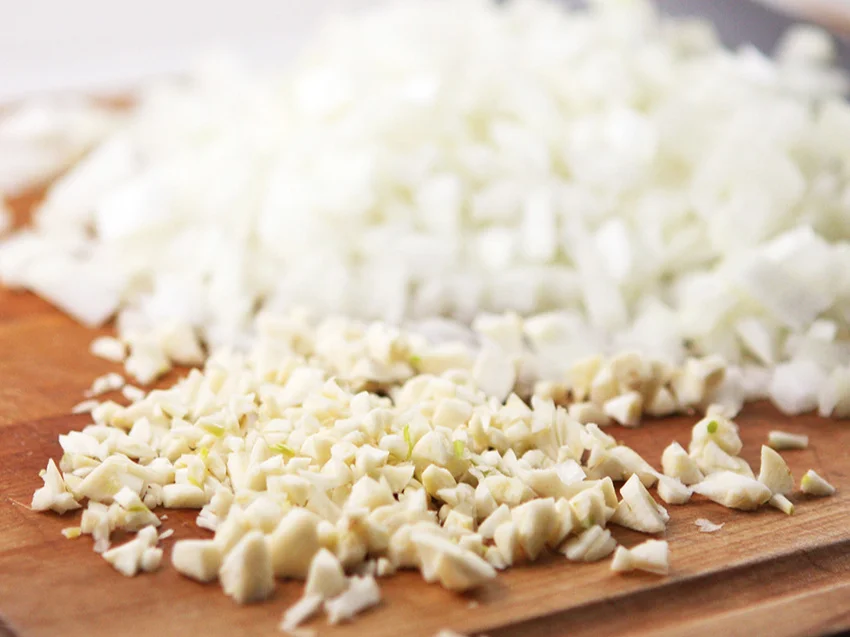  Chopped onion and garlic on cutting board 