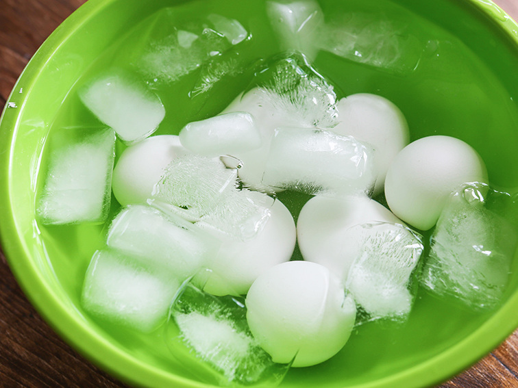 Hard boiled eggs sitting in an ice bath 