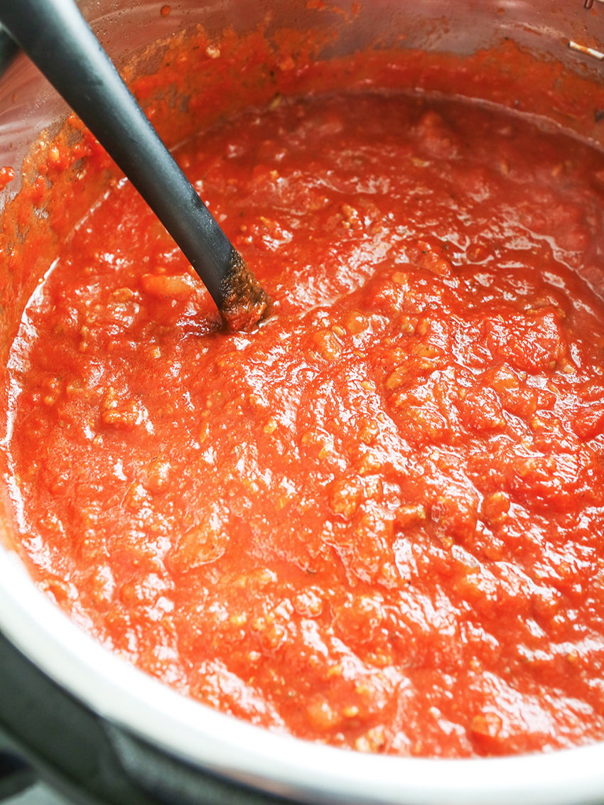 Instant Pot full of pasta sauce with ladle 