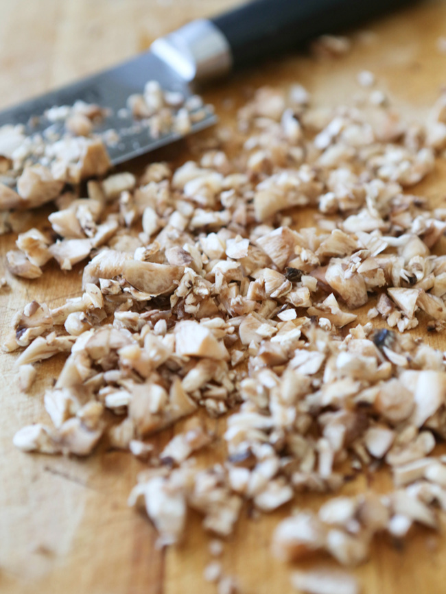  Chopped mushrooms on cutting board with knife 