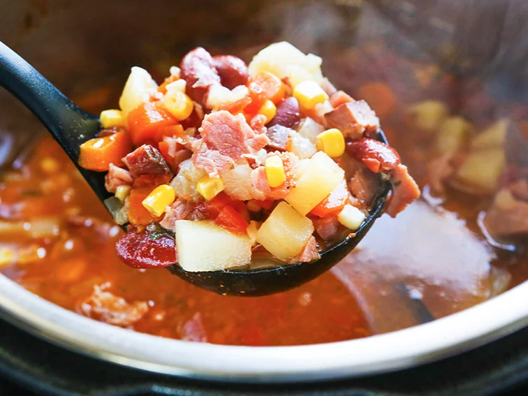 ladle filled with ham soup hovering over an Instant Pot