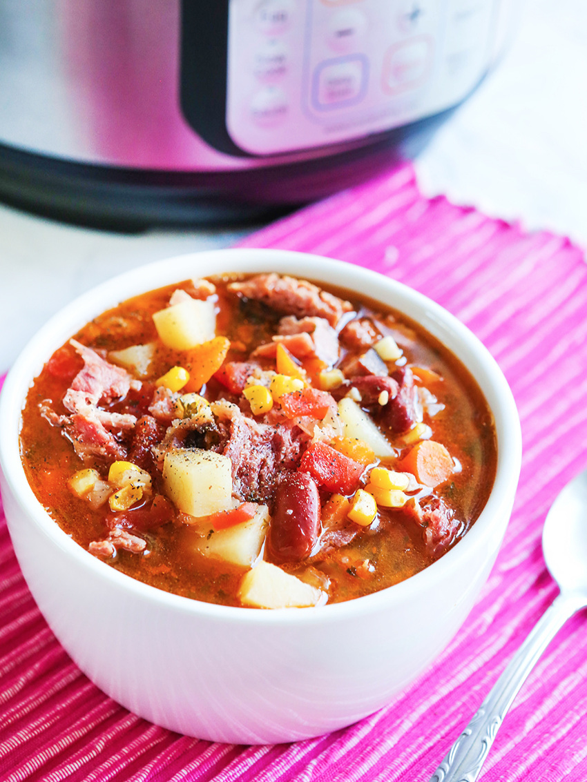 Bowl of ham soup sitting next to an Instant Pot