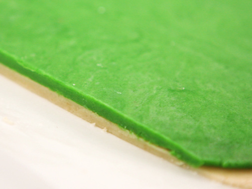 photo of green dough layered over white, ready to roll