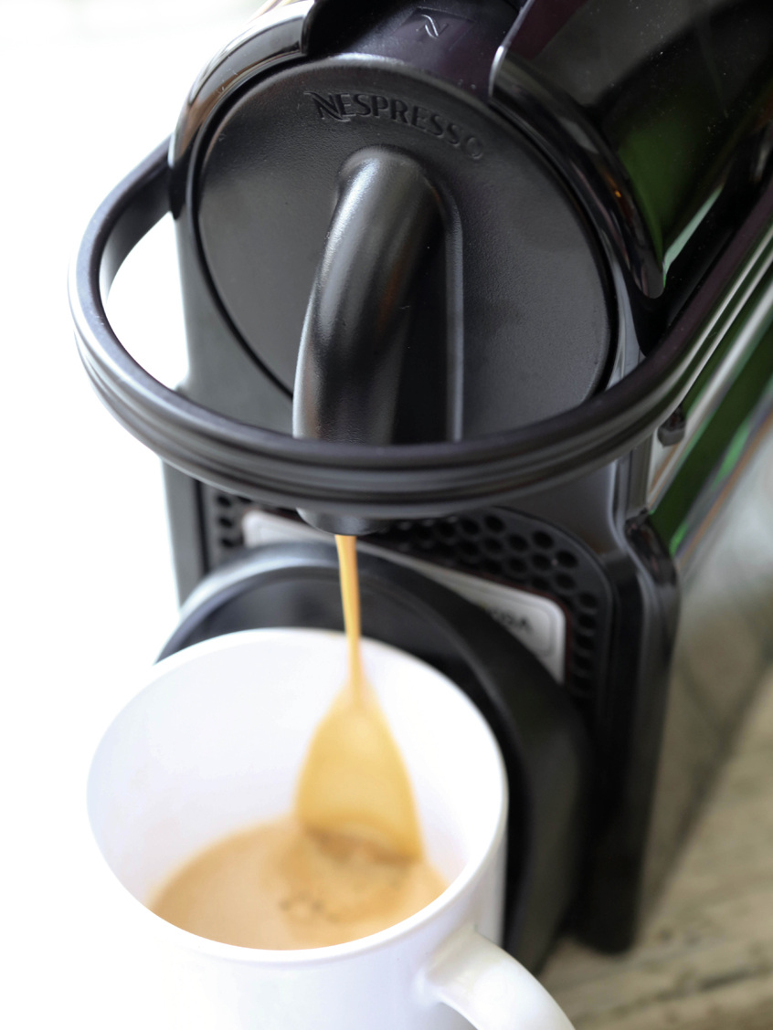 Nespresso pouring coffee into a mug