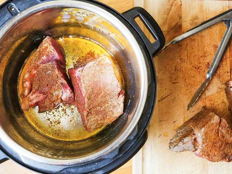 top view of the pot roast sauteing in the instant pot