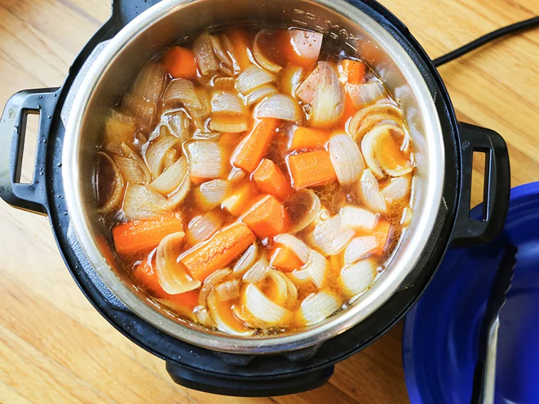 top view of potatoes, onions and carrots inside the instant pot