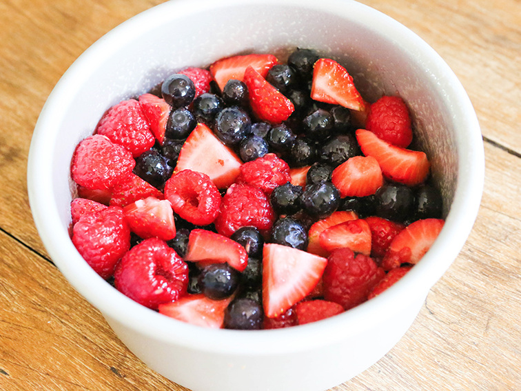 berries soaking in sugar in a cake pan