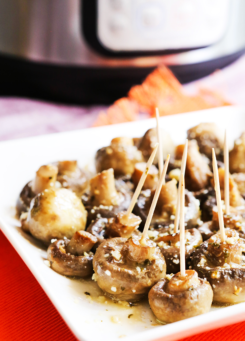 Instant Pot Mushrooms on serving plate with toothpicks stabbed into them 