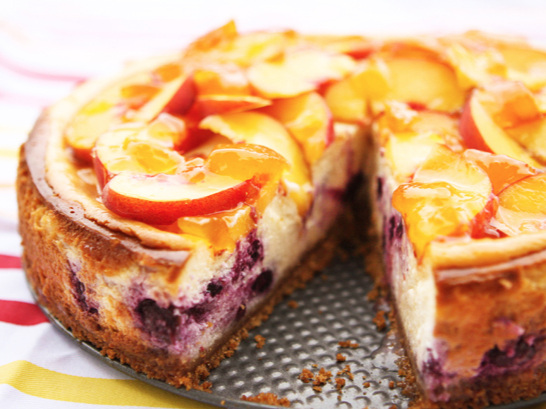  blueberry peach cheesecake with slice removed 