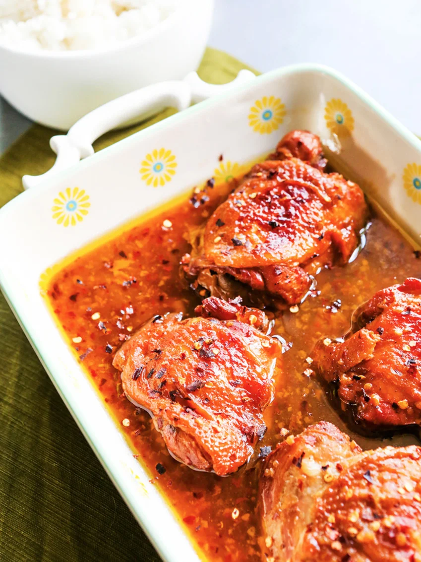 Serving dish of cooked INSTANT POT honey garlic chicken sitting in the sauce