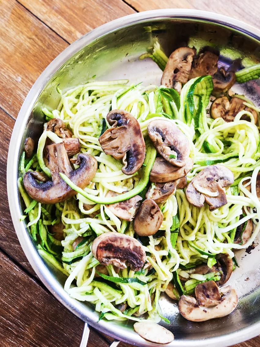 top view of a skillet filled with sauteed zoodles and mushrooms