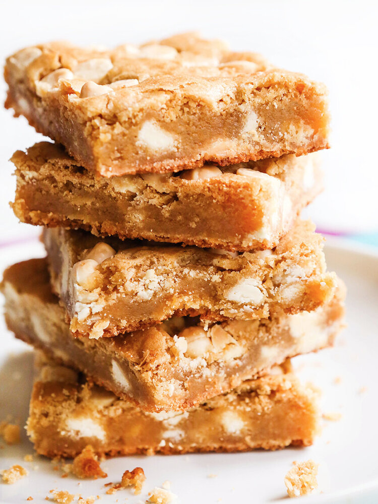 stack of blonde brownies on a plate
