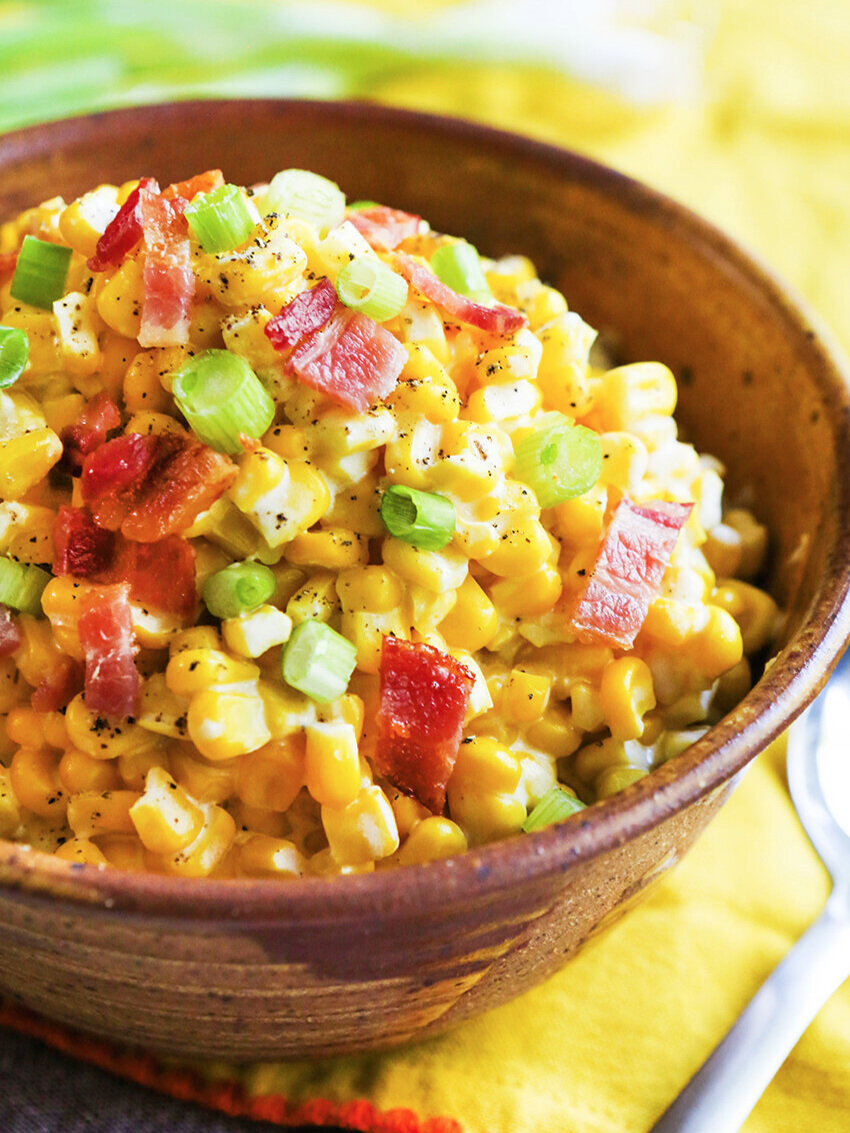  Close up bowl of creamed corn with bacon and green onions 
